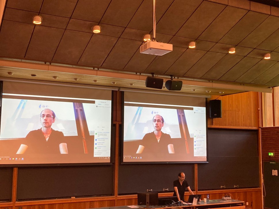 Photo of me (Indrapramit Das) giving a keynote reading at a lecture hall in the University of Oslo's Science Library.